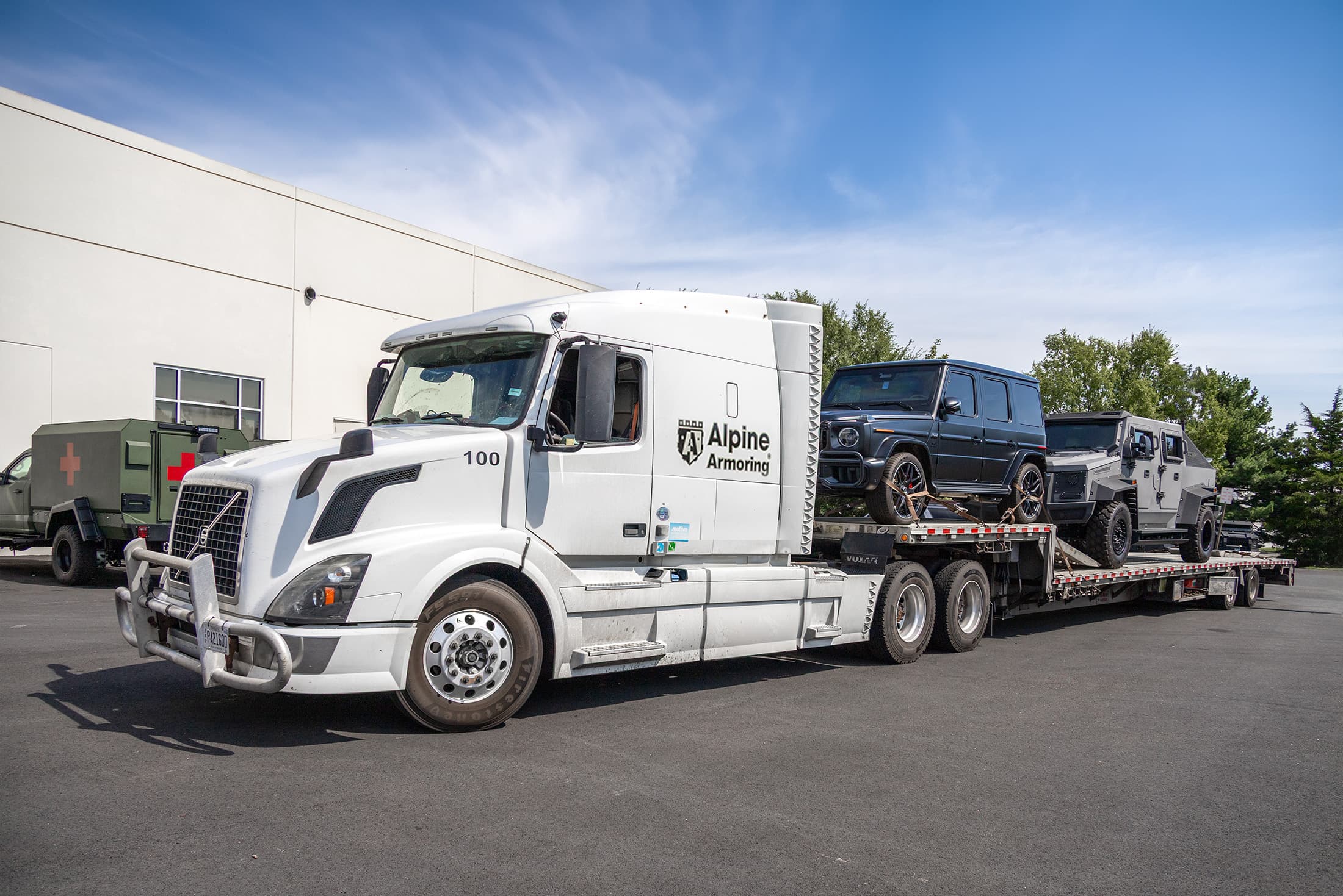 Alpine Armoring transport truck delivering an armored rental vehicle